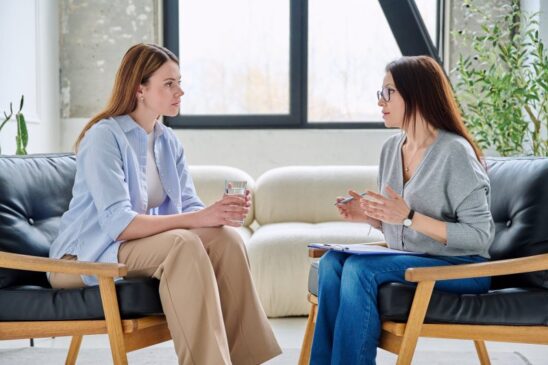 woman listens intently to her therapist during private session