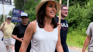 Hawaii Rep. Tulsi Gabbard, seen in Franconia, N.H., on July 6, is one of nearly two dozen Democrats running for president. A major in the Hawaii Army National Guard, she served two tours of duty in the Middle East and says that the experience informed her concern about "wasteful regime change wars."
