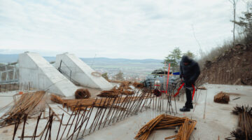 SATORALJAUJHELY, HUNGARY - DECEMBER 15: Attila Kecskes, head of the building site, carries out a general inspection of the building process of the world's longest two-way suspension bridge, which is expected to be officially opened to the public around April-May 2024, in Satoraljaujhely, Hungary on December 15, 2023. The nearly 800-meter-long structure connects the two points of the city, Var-Hill and Szar-Hill, at a height of 80 meters. The bridge, which will have a glass floor in the central part, is being built as part of the Tokaj-Zemplen Development Programme, with a budget of £9.3 million (HUF 4 billion). The walkway will have a width of 1.2m and descend by 27m at its lowest point, resulting in a 15% steepness at its most extreme. The design of bridge prioritizes minimal physical impact on the landscape, eliminating the need for large pylons. Additionally, the footpath has been crafted to seamlessly blend into the silhouettes of the surrounding mountains. The new pedestrian bridge will later become part of the Zemplen Adventure Park, a fully municipal project. (Photo by Robert Nemeti/Anadolu via Getty Images)
