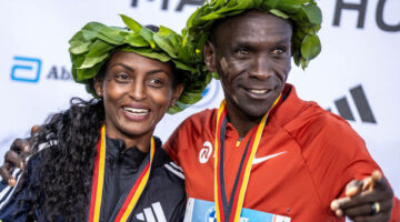 24 September 2023, Berlin: Athletics: Berlin Marathon. Winner Tigst Assefa (l) from Ethiopia stands laughing next to winner Eliud Kipchoge from Kenya at the award ceremony. Photo: Andreas Gora/dpa (Photo by Andreas Gora/picture alliance via Getty Images)