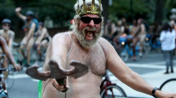 People ride bikes around Washington Square onto Walnut Street in Philadelphia during the Philly Naked Bike Ride, Saturday, Aug. 27, 2022.