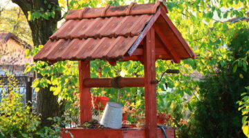 Wooden water well in the garden