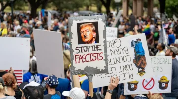 anti trump protest with sign saying stop the fascists.jpg