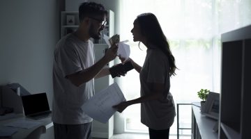 asian couple arguing about money at home.