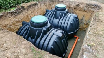 Two plastic underground storage tanks placed below ground for harvesting a rainwater.