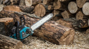 Man chopping wood with a chainsaw ,close-up