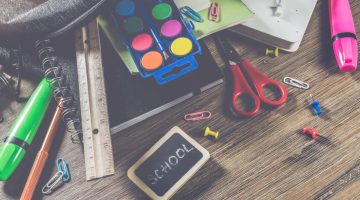 backpack with school supplies, top view. back to school concept