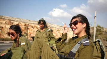 Israeli soldiers wait for a bus near Ramallah. October 1, 2009. Photo by Matanya Tausig/Flash 90