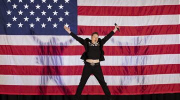 TOPSHOT - Tesla and SpaceX CEO Elon Musk jumps on stage as he arrives to speak at a town hall event hosted by America PAC in support of former US President and Republican presidential candidate Donald Trump at the Greater Philadelphia Expo Center in Oaks, Pennsylvania, on October 18, 2024. Musk is holding several events in the key swing-state of Pennsylvania in support of former US President and Republican presidential candidate Donald Trump. (Photo by RYAN COLLERD / AFP) (Photo by RYAN COLLERD/AFP via Getty Images)