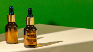 Oily skincare moistrizing brown glass jar with pipette close up