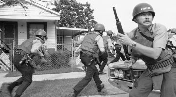 1970 new orleans police officers try to keep their heads down as they move in on a black panther headquarters during an exchange of gunfire