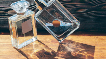 different perfume bottles on the wooden background
